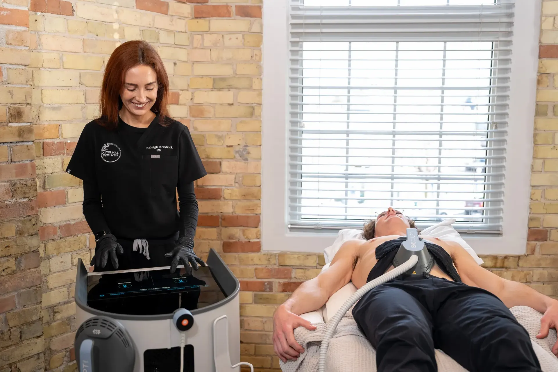 Patient receiving Functional Emsculpt Neo treatment for core strengthening at Eternal Wellness Medical Spa in Traverse City