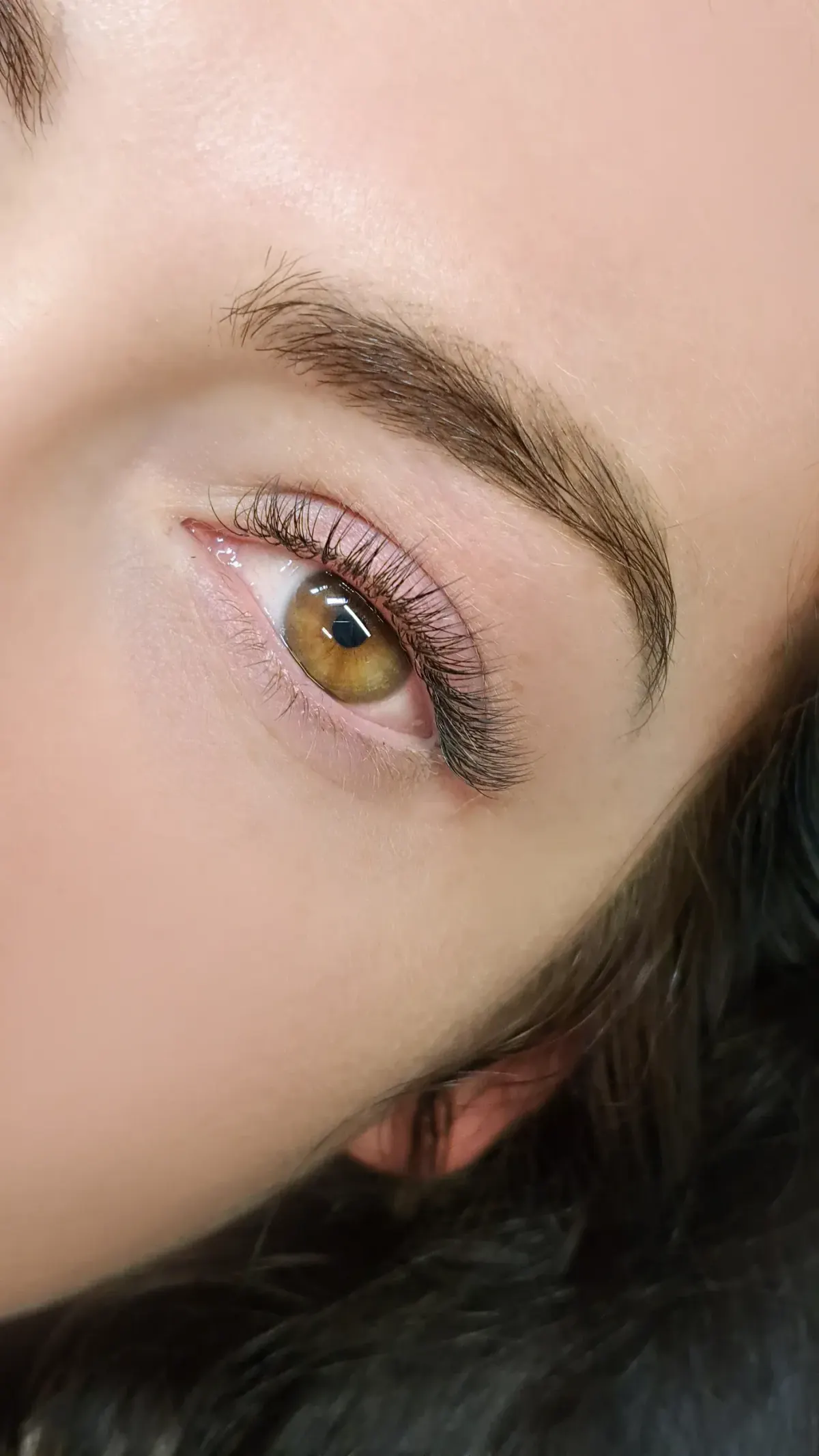 Confident patient portrait after lash lift and tint at Eternal Wellness Traverse City